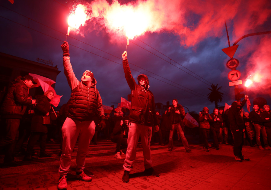 Demonstrators burn flares and wave Polish flags during the annual march to commemorate Poland's National Independence Day in Warsaw Photo By: AGENCJA GAZETA/ADAM STEPIEN VIA REUTERS Demonstrators march during the annual Poland's National Independence Day in Warsaw