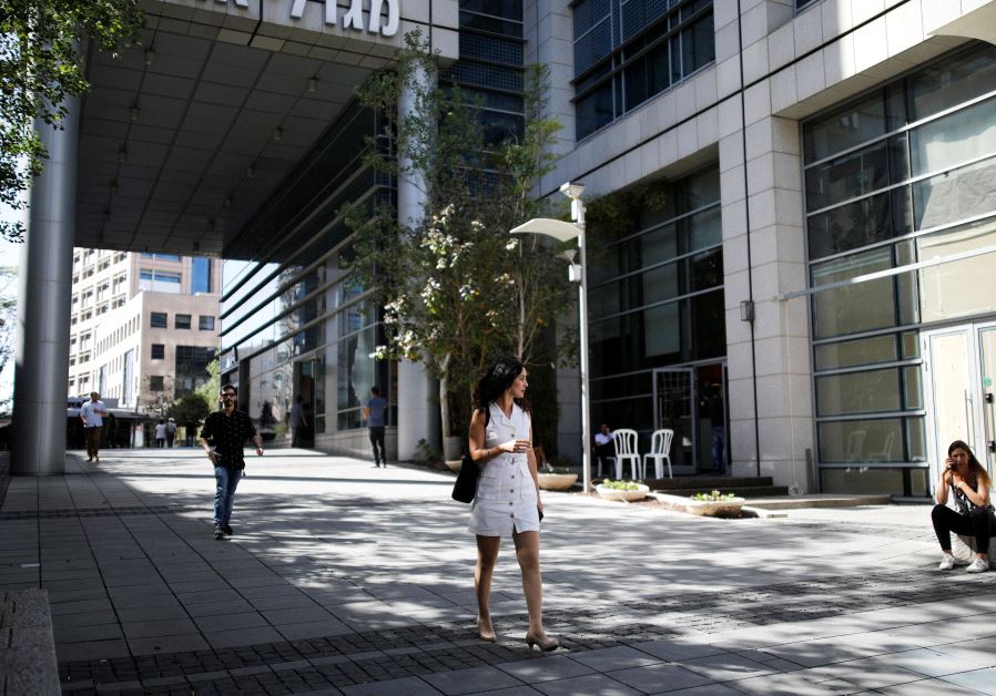 A woman walks near high-rise buildings in the hi-tech business area of Tel Aviv Photo By: REUTERS/AMIR COHEN woman hi tech tel aviv