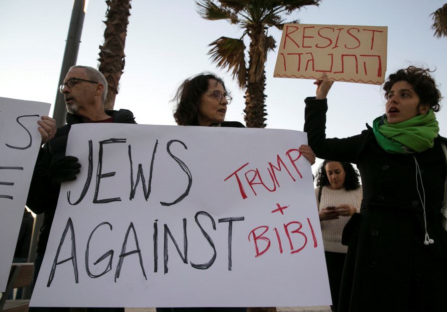 Protestors hold placards during a rally supporting refugees worldwide and in reaction to Trump's travel ban, outside the US embassy in Tel Aviv, Israel January 29, 2017 Photo By: REUTERS Trump immigration