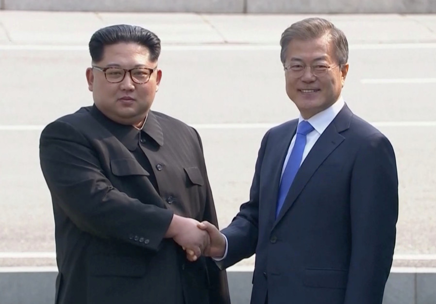 North Korean leader Kim Jong Un shakes hands with South Korean President Moon Jae-in as both of them arrive for the inter-Korean summit at the truce village of Panmunjom, April 27, 2018 Photo By: HOST BROADCASTER VIA REUTERS TV Smiling and holding hands, leaders of two Koreas meet at historic summit