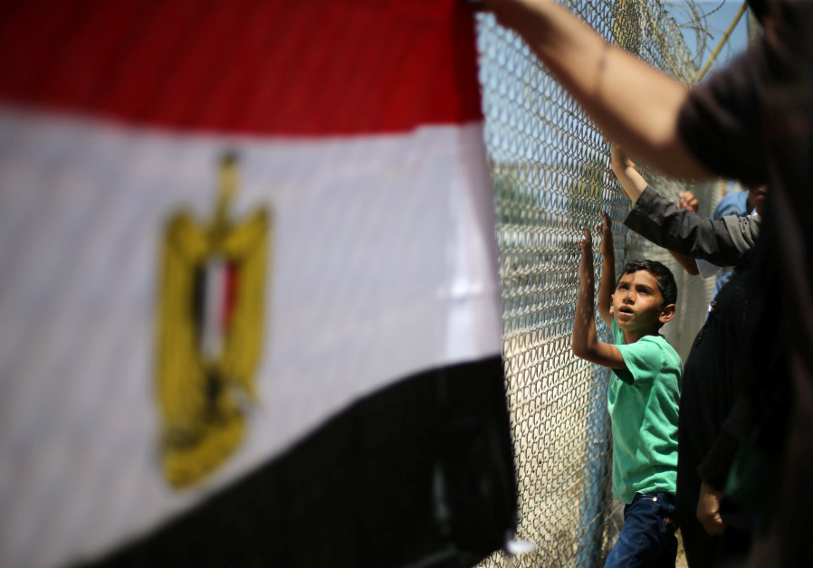 Palestinians gather in front of the gate of Rafah border crossing between Egypt and Gaza during a protest against the blockade, in the southern Gaza Strip July 3, 2017. Photo By: REUTERS/IBRAHEEM ABU MUSTAFA Analysis: Gaza’s agony is Egypt’s calling