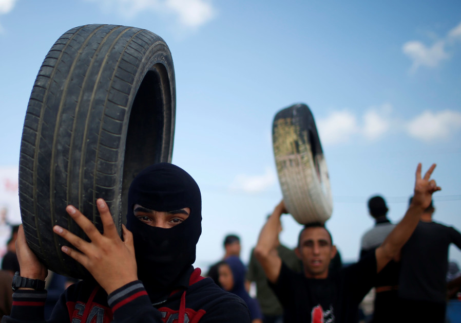 Palestinian demonstrators carry tires during a protest against U.S. embassy move to Jerusalem and ahead of the 70th anniversary of Nakba, at the Israel-Gaza border, east of Gaza City May 14, 2018. Photo By: REUTERS/MOHAMMED SALEM Israel won against Hamas in Gaza but achieved nothing