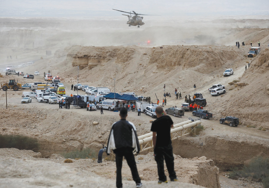 Israeli rescue service personnel operate near the site where 10 Israeli youths were swept away by a flash flood south of the Dead Sea on April 26 Photo By: AMIR COHEN/REUTERS Israeli rescue service personnel operate near the site where 10 Israeli youths were swept away by a
