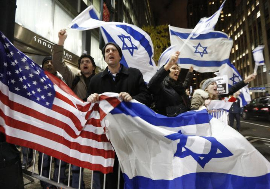 People hold U.S. and Israel flags as they chant during a Pro-Israel rally outside the Israeli consulate in New York November 19, 2012. Photo By: BRENDAN MCDERMID/REUTERS People hold U.S. and Israel flags as they chant during a Pro-Israel rally.
