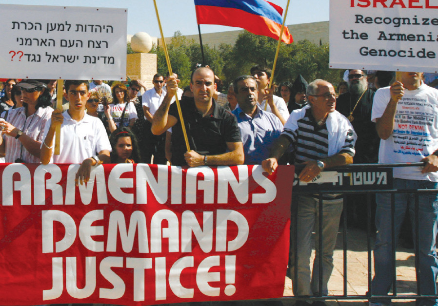 Members of the Armenian community in Israel attend a demonstration against Israel’s stance on the 1915 massacre of Armenians by Ottoman Turks outside the Foreign Ministry in Jerusalem; the sign on the left reads: ‘Judaism is for acknowledgement of Armenian Genocide, the State of Israel against?’ Photo By: RONEN ZVULUN / REUTERS armenian genocide jerusalem