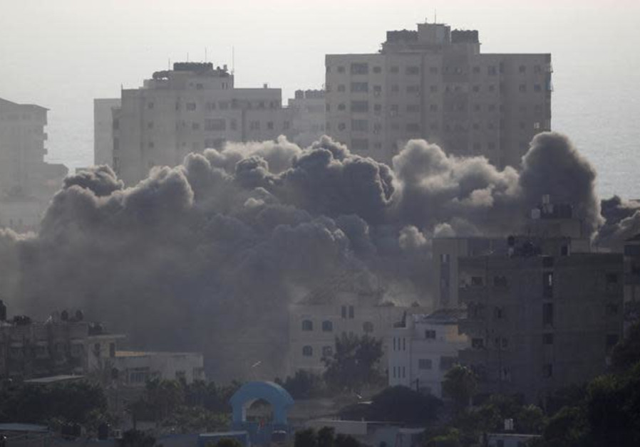 Smoke rises following an Israeli strike on a building in Gaza City July 14, 2018 Photo By: AHMED ZAKOT / REUTERS Smoke rises following an Israeli strike on a building in Gaza City July 14, 2018