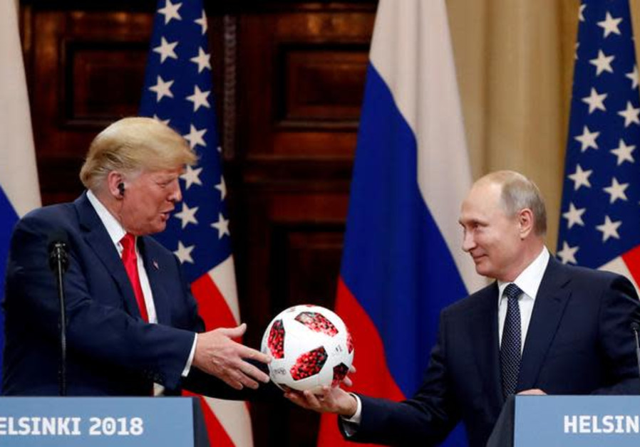 U.S. President Donald Trump receives a football from Russian President Vladimir Putin as they hold a joint news conference after their meeting in Helsinki, Finland July 16, 2018 Photo By: GRIGORY DUKOR / REUTERS U.S. President Donald Trump receives a football from Russian President Vladimir Putin