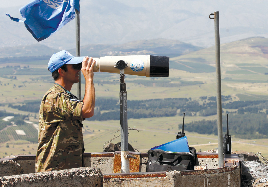 A UNITED NATIONS observer keeps watch over the Syrian border from the Golan Heights, May 2018 Photo By: REUTERS A UNITED NATIONS observer keeps watch over the Syrian border from the Golan Heights, May 2018