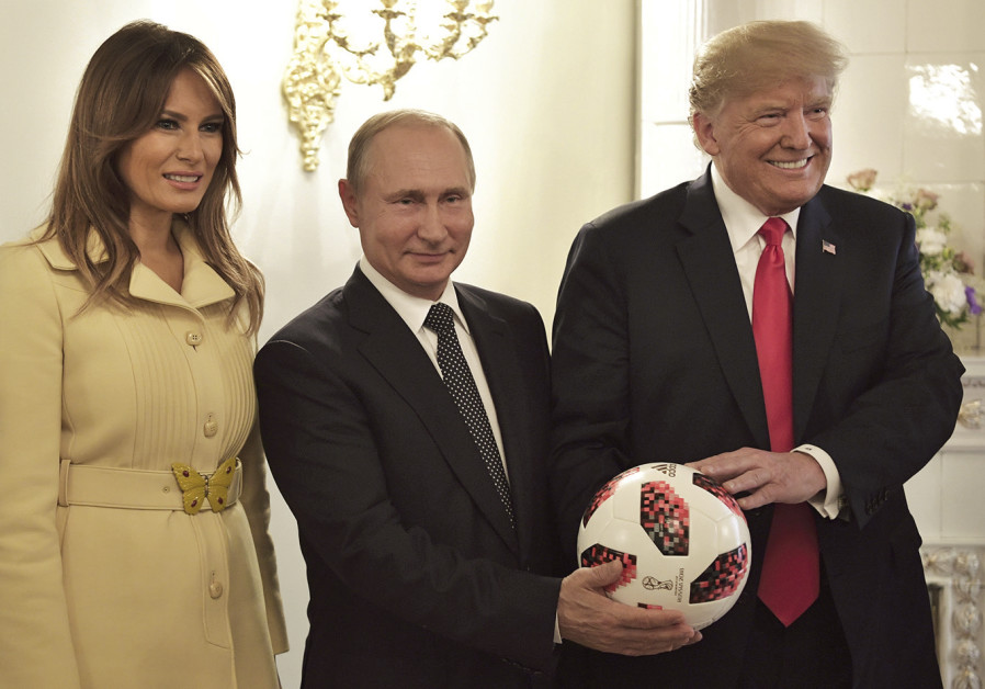 RUSSIAN PRESIDENT Vladimir Putin, US President Donald Trump and first lady Melania Trump pose with an official World Cup soccer ball at their summit in Helsinki. Photo By: SPUTNIK/ALEXEI NIKOLSKY/KREMLIN RUSSIAN PRESIDENT Vladimir Putin, US President Donald Trump and first lady Melania Trump pose with a
