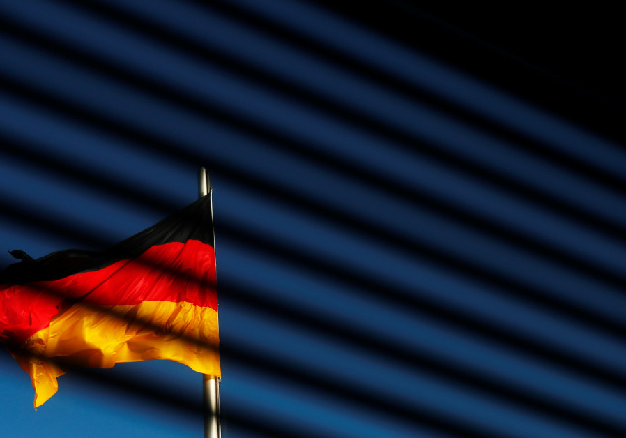The German flag is pictured at the Reichstag building in Berlin, Germany, November 7, 2017 Photo By: REUTERS/HANNIBAL HANSCHKE German businesses suffering as U.S. sanctions and tariffs bite