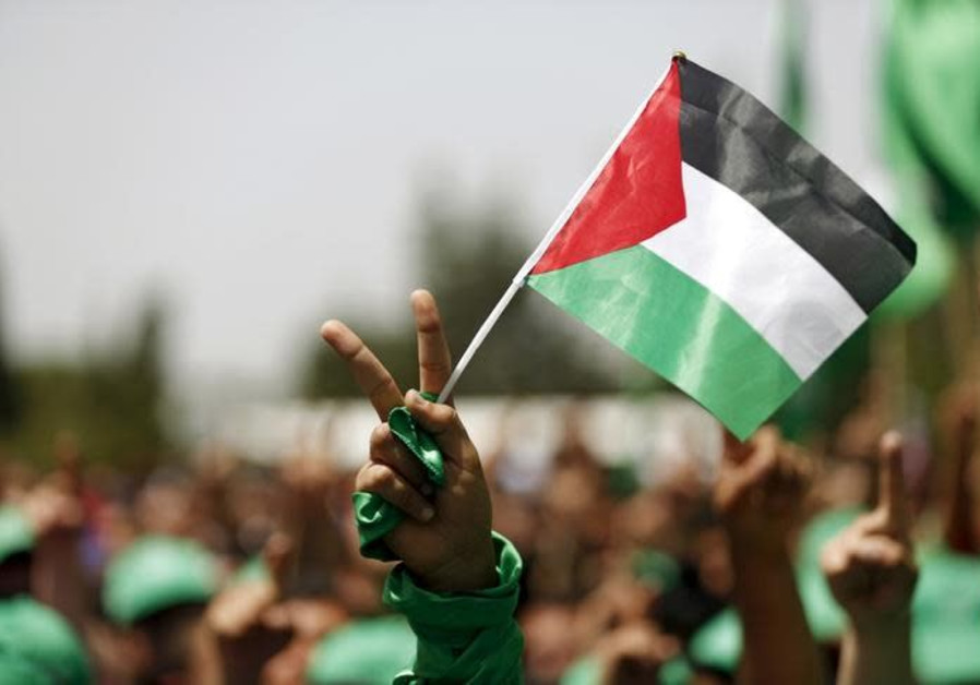 A student supporting Hamas holds a Palestinian flag in a rally during an election campaign for the student council at the Birzeit University in the West Bank city of Ramallah April 26, 2016 Photo By: MOHAMAD TOROKMAN/REUTERS Hamas: Israel did not offer us an airport near Eilat