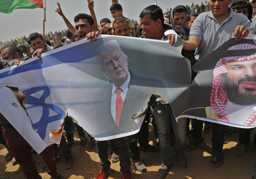 Palestinians prepare to set fire on an Israeli flag and portraits of US President Donald Trump and Saudi Crown Prince Mohammed bin Salman during a protest at the border fence with Israel, east of Khan Yunis in the southern Gaza city, on April 13, 2018 Photo By: THOMAS COEX / AFP Palestinians set fire to Israeli flag, US President Trump and Saudi Crown Prince Mohammed bin Salman