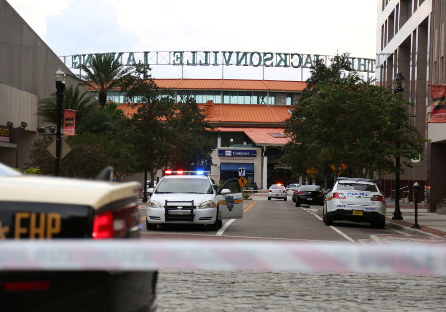 Police officers cordon off a street outside The Jacksonville Landing after a shooting during a video game tournament in Jacksonville, Florida August 26, 2018 Photo By: REUTERS/JOEY ROULETTE Police officers cordon off a street outside The Jacksonville Landing after a shooting during a video