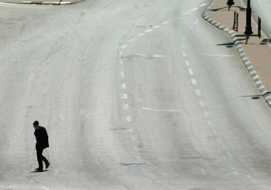 A MAN walks on an empty street in Jerusalem during Yom Kippur in this file photo from 2004. Photo By: REINHARD KRAUSE/REUTERS A MAN walks on an empty street in Jerusalem during Yom Kippur in this file photo from 2004.