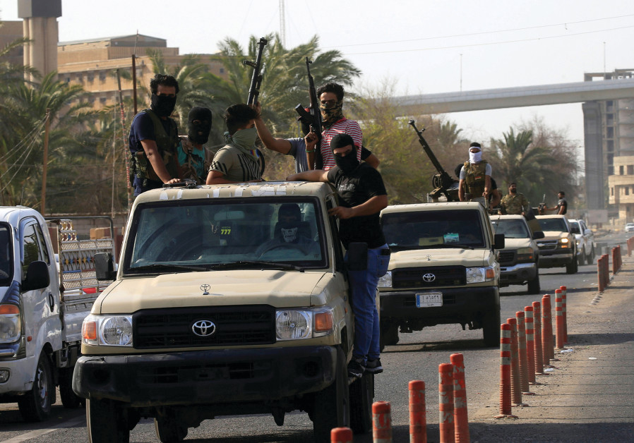 VEHICLES OF Iraq’s Popular Mobilization Forces patrol the streets of Basra last week. Photo By: REUTERS VEHICLES OF Iraq’s Popular Mobilization Forces patrol the streets of Basra last week.