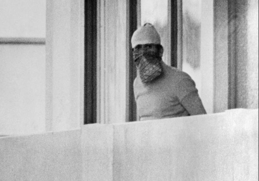A member of the Palestinian terrorist group Black September appears on the balcony of the Israeli house at the Munich Olympic village on September 5, 1972 Photo By: AFP PHOTO A member of the Palestinian terrorist group Black September