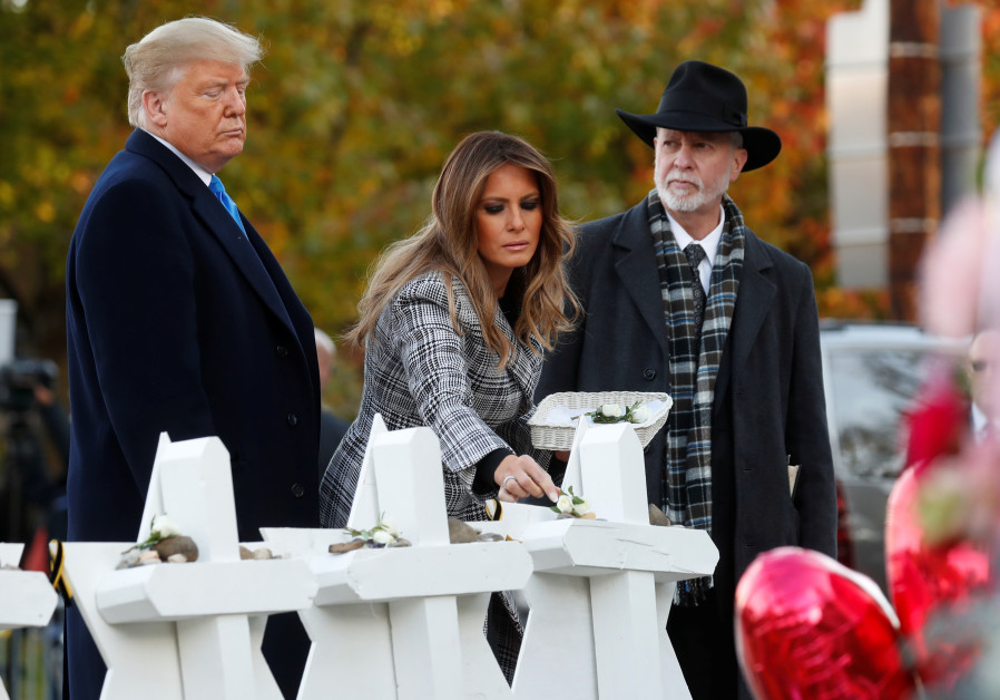 U.S. President Donald Trump and first lady Melania Trump stand with Rabbi Jeffrey Myers as they place stones at a makeshift memorial outside the Tree of Life synagogue in the wake of the shooting at the synagogue where 11 people were killed and six people were wounded in Pittsburgh, Pennsylvania, Photo By: KEVIN LAMARQUE/REUTERS Protests meet Trumps in Pittsburgh