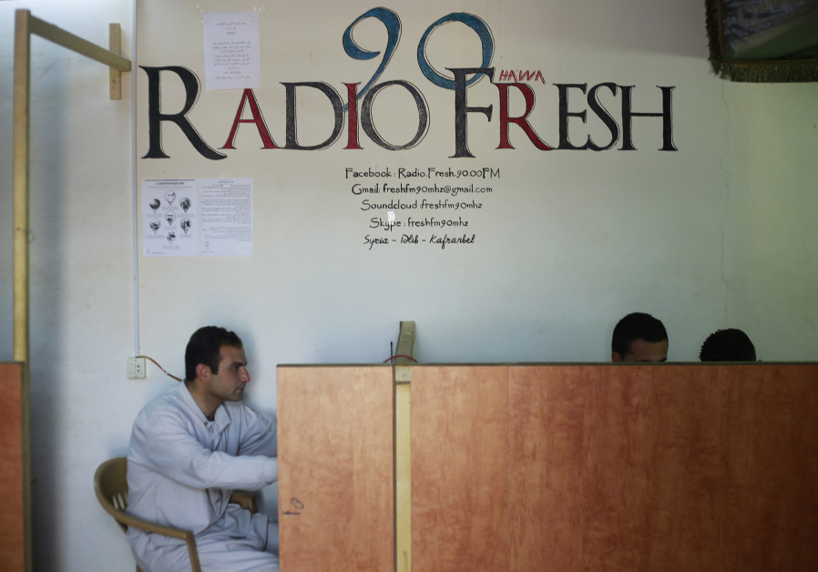 Activists sit at the premises of the Radio Fresh station in Kafranbel town in the Idlib governorate Photo By: REUTERS/HAMID KHATIB Raed Fares