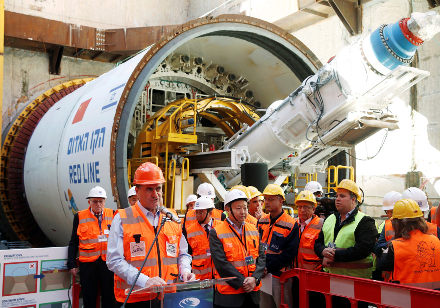Yisrael Katz, Israel's Minister of Transport, speaks as he stands next to employees of China Railway Engineering Corporation, during an event marking the beginning of underground construction work of the light rail, using a Tunnel Boring Machine (TBM), in Tel Aviv, Israel February 19, 2017. Photo By: BAZ RATNER/REUTERS Yisrael Katz speaks as he stands next to employees of China Railway Engineering Corporation
