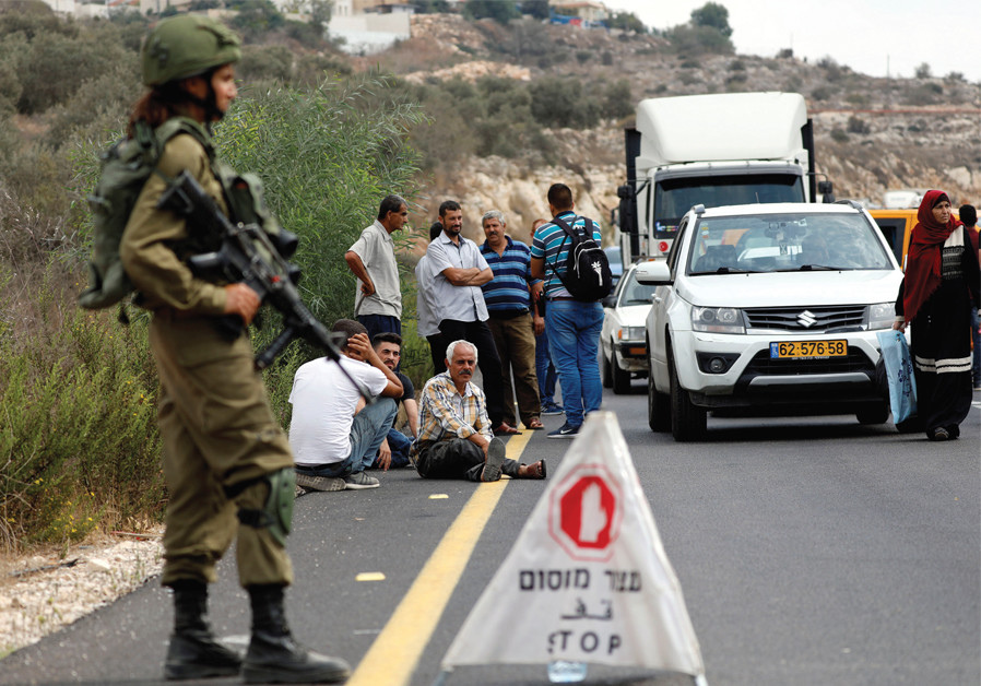 PALESTINIANS WAIT at an IDF checkpoint in the West Bank late last year. Photo By: MOHAMAD TOROKMAN/REUTERS Mossad, Shin Bet officials tackle Israel's toughest challenges