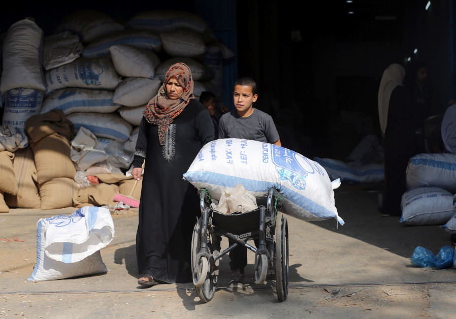 A Palestinian boy uses a wheelchair to transport a bag of peanuts as he helps his mother who makes a living by peeling peanuts for a factory, in Rafah in the southern Gaza Strip January 22, 2019. Photo By: IBRAHEEM ABU MUSTAFA / REUTERS U.N. signs agreement with Qatar for one-time $20 million grant for Gaza