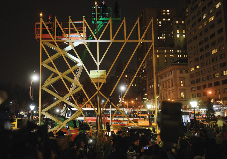 A RABBI lights the ‘World’s Largest Menorah’ in Manhattan in 2017. Photo By: ANDREW SAVULICH/TNS Unorthodox Judaism in the U.S. and the 'criteria' of identifying as Jewish