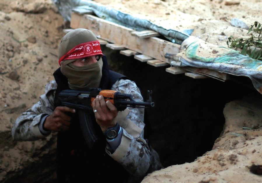 A Palestinian fighter takes part in a tunnel attack simulation during a graduation ceremony in Rafah, in the southern Gaza Strip, last November Photo By: REUTERS Hamas ceremony