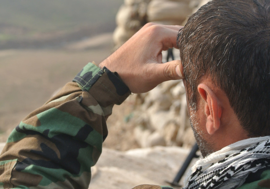 A PAK member looks out over a frontline during the war on ISIS in Iraq in 2016. Photo By: SETH J. FRANTZMAN A PAK member looks out over a frontline during the war on ISIS in Iraq in 2016.