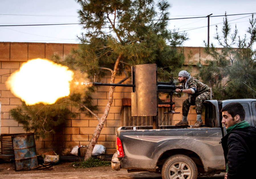 A fighter of the Kurdish People's Protection Units (YPG) fires an anti-aircraft weapon from Tel Tawil village in the direction of Islamic State fighters positioned in the countryside of the town of Tel Tamr, Syria Photo By: REUTERS Islamic State defeated, 'caliphate' eliminated - U.S.-backed SDF