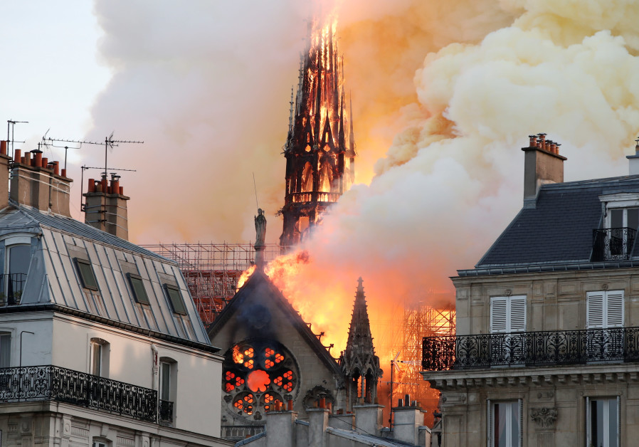 Smoke billows as fire engulfs the spire of Notre Dame Cathedral in Paris, France April 15, 2019 Photo By: REUTERS/BENOIT TESSIER Smoke billows as fire engulfs the spire of Notre Dame Cathedral in Paris, France April 15, 2019