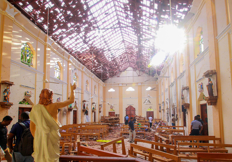A blood-spattered statue of Jesus Christ is pictured while crime scene officials inspect the site of a bomb blast, as the sun shines through the blown-out roof, inside St Sebastian's Church in Negombo, Sri Lanka April 21, 2019 Photo By: REUTERS A blood-spattered statue of Jesus Christ inside St Sebastian's Church in Negombo, Sri Lanka April