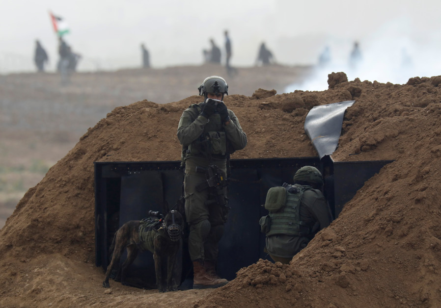 Israeli soldiers wait in position near the border fence between Israel and the Gaza Strip, during a protest on the Gaza side, as seen from the Israeli side March 30, 2019 Photo By: REUTERS/AMIR COHEN Israeli soldiers wait in position near the border fence between Israel and the Gaza Strip