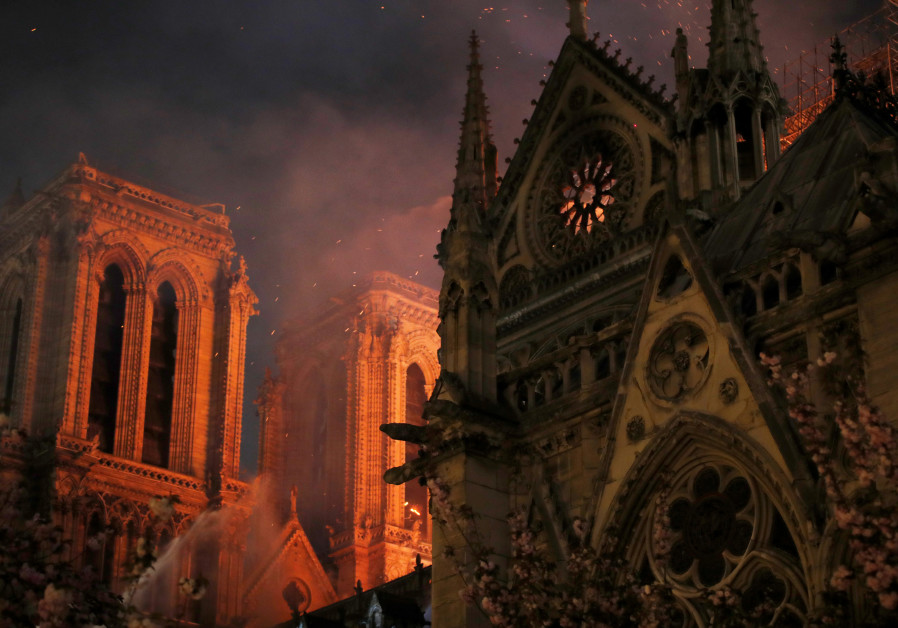 Sparks fill the air as Paris Fire brigade members spray water to extinguish flames as the Notre Dame Cathedral burns in Paris, France, April 15, 2019. Photo By: PHILIPPE WOJAZER/REUTERS Sparks fill the air as Paris Fire brigade members spray water to extinguish flames as the Notre Dame