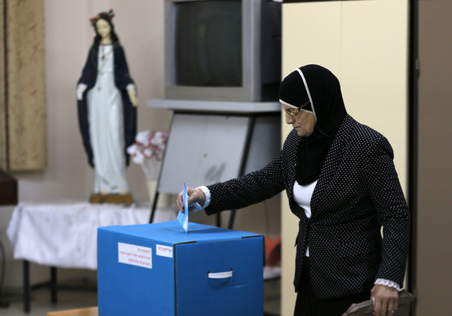 An Israeli Arab casts her ballot at a polling station inside a church in the northern town of Reineh, March 17, 2015. Photo By: AMMAR AWAD / REUTERS An Israeli Arab casts her ballot at a polling station in the northern town of Reineh, in 2015