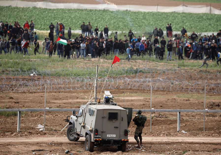 IDF troops face Palestinian protesters over the border fence between Israel and the Gaza Strip on March 30, a year after they began the ‘Great March of Return’ demonstrations Photo By: AMIR COHEN/REUTERS The Gaza quandary