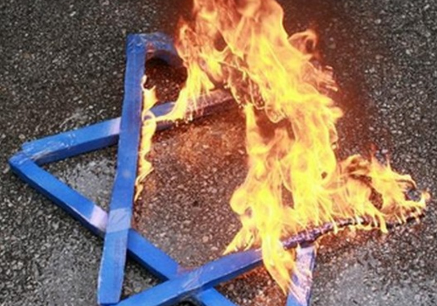 A Star of David burns in flames. Photo By: REUTERS Star of David burns