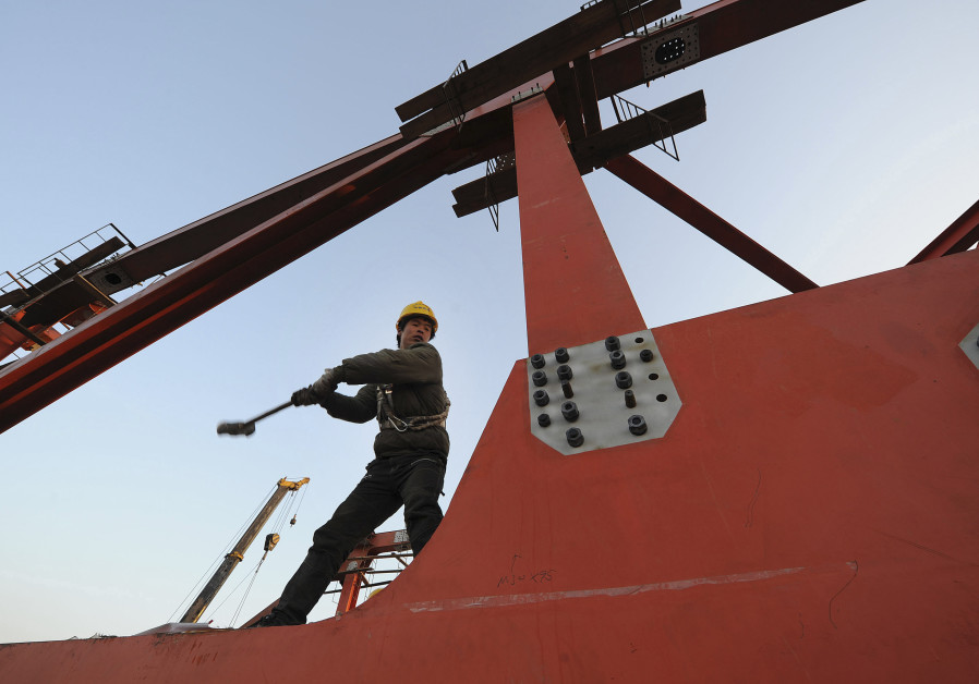 A labourer works at a high-speed railway viaduct construction site in Hefei, Anhui province January 4, 2011. Photo By: REUTERS A labourer works at a high-speed railway viaduct construction site in Hefei, Anhui province