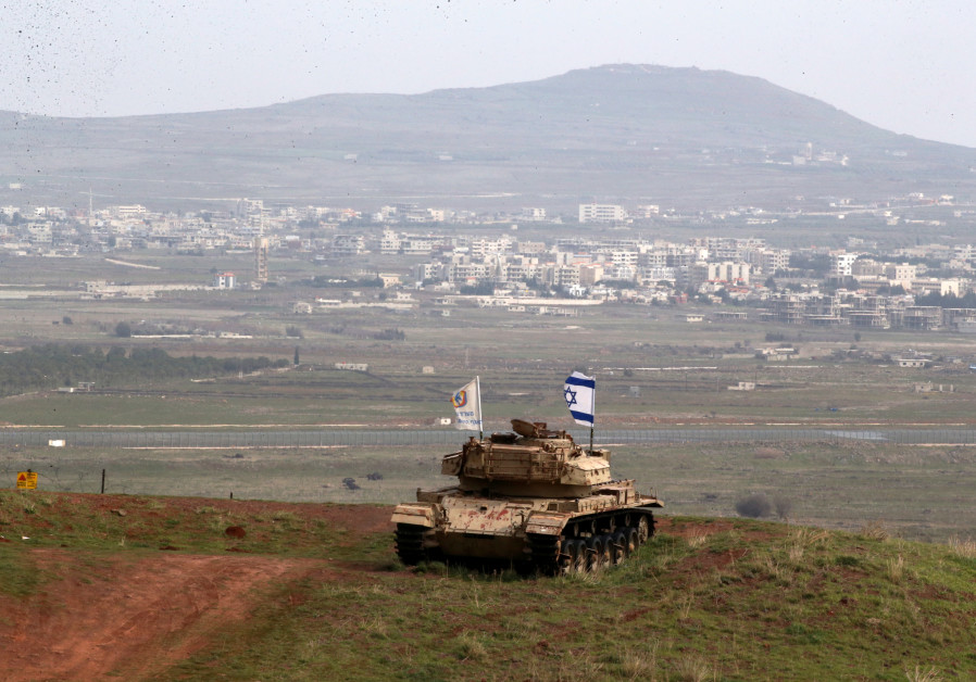 An old military vehicle can be seen positioned on the Israeli side of the border with Syria, near the Druze village of Majdal Shams in the Golan Heights Photo By: AMMAR AWAD/REUTERS An old military vehicle can be seen positioned on the Israeli side of the border with Syria, near th