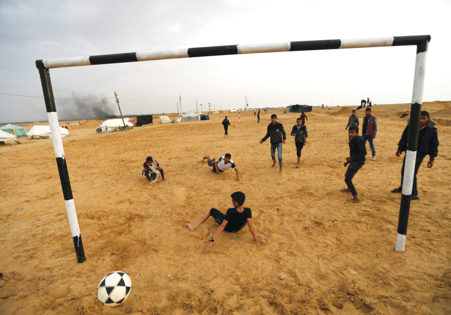 PALESTINIANS PLAY soccer at a tent city in the southern Gaza Strip last year. Photo By: IBRAHEEM ABU MUSTAFA/REUTERS PALESTINIANS PLAY soccer at a tent city in the southern Gaza Strip last year.