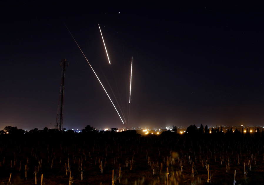 Streaks of light are pictured as rockets are launched from the Gaza Strip towards Israel, as seen from the Israeli side of the border March 25, 2019 Photo By: REUTERS/AMIR COHEN Streaks of light are pictured as rockets are launched from the Gaza Strip towards Israel, as seen fr