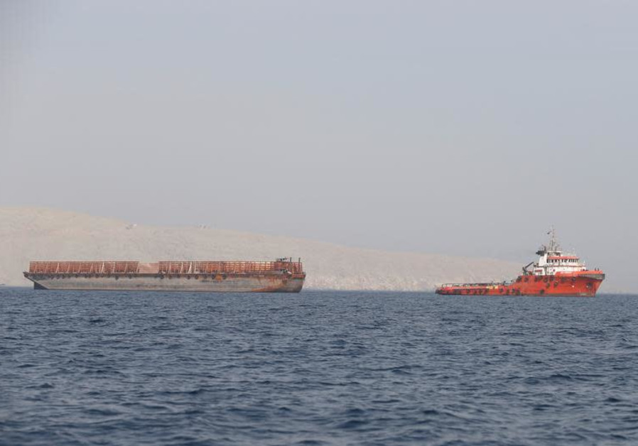 A tugboat moves cargo towards the Strait of Hormuz off the coast of Musandam province, Oman, July 20, 2018 Photo By: HAMAD I MOHAMMED/REUTERS Oman, Strait of Hormuz