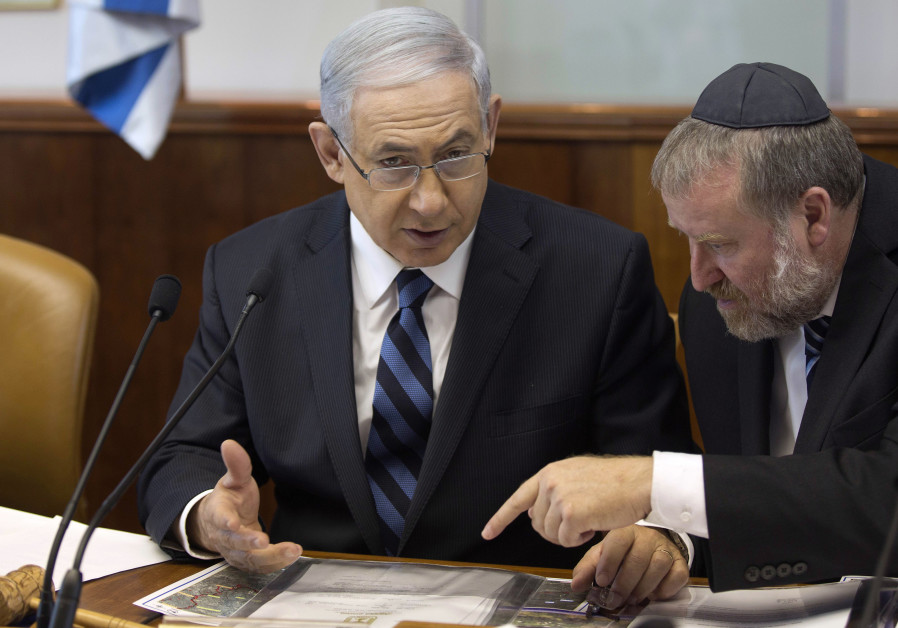 Israel's Prime Minister Benjamin Netanyahu speaks with Cabinet Secretary Avichai Mandelblit (R) during the weekly cabinet meeting in Jerusalem Photo By: MENAHEM KAHANA / REUTERS Netanyahu, Mandelblit may head to High Court over pre-indictment hearing date