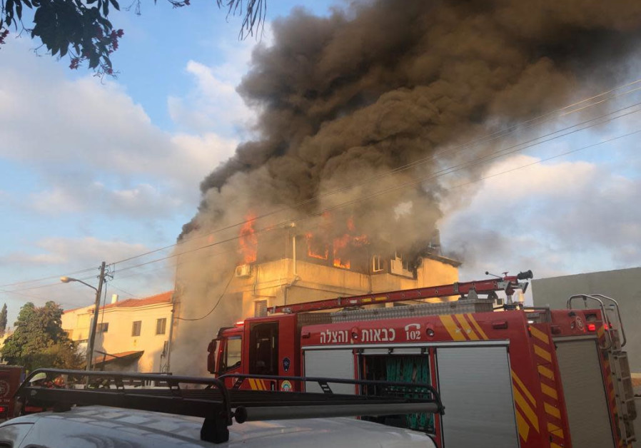 The house of Carmel Mauda burning Photo By: POLICE SPOKESPERSON'S UNIT The house of Carmel Mauda burning