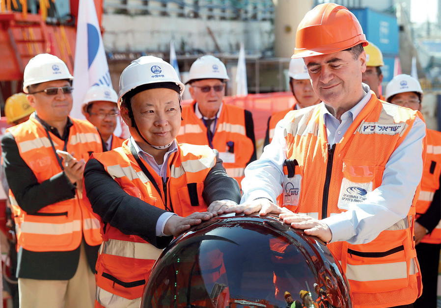 Previous transportation minister Israel Katz and employees of the China Railway Engineering Corporation take part in an event in 2017 marking the beginning of underground construction work of the Tel Aviv light rail, using a Tunnel Boring Machine (TBM) Photo By: BAZ RATNER/REUTERS Over U.S. objections, Chinese firms step up their involvement in Israel