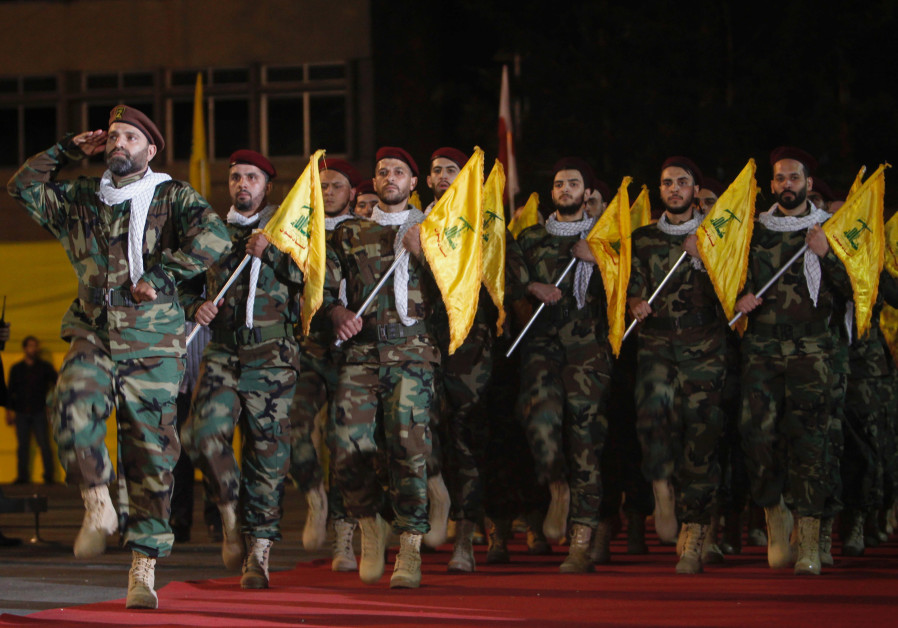 Members of Hezbollah march with party's flags during a rally marking al-Quds Day, (Jerusalem Day) in Beirut Photo By: REUTERS Members of Hezbollah march with party's flags during a rally marking al-Quds Day, (Jerusalem Day) in