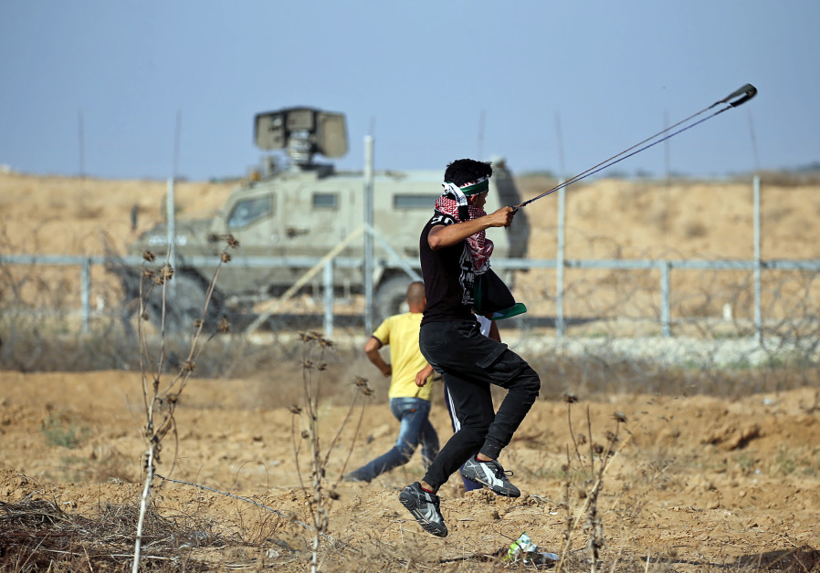 A Palestinian demonstrator uses a sling to hurl stones at Israeli forces during a protest at the Israel-Gaza border fence, in the southern Gaza Strip June 21, 2019 Photo By: IBRAHEEM ABU MUSTAFA / REUTERS Escalation expected at the Gaza border - report