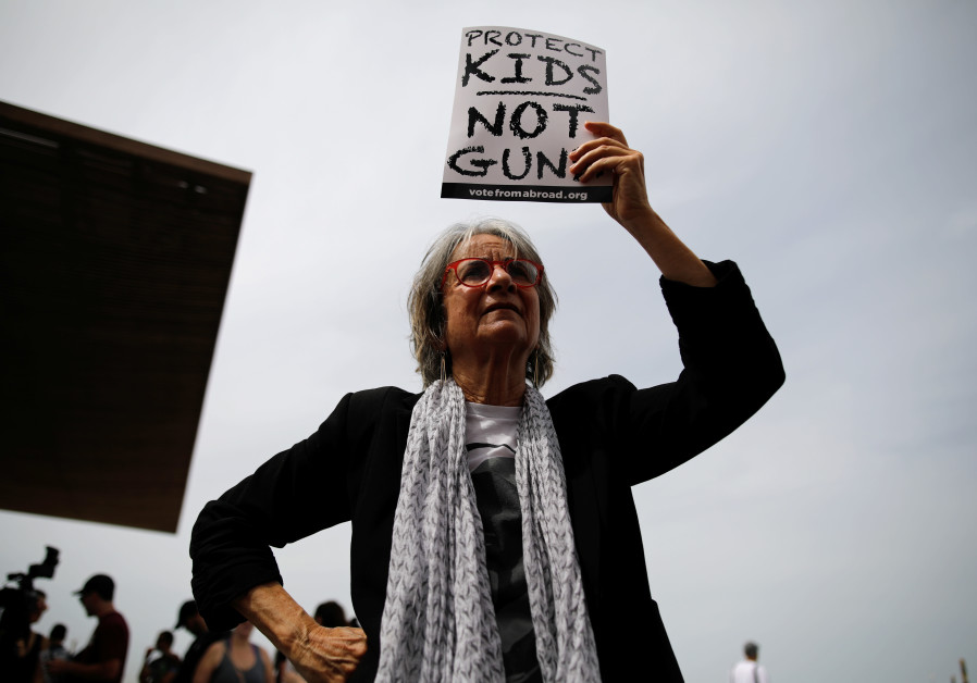 A woman takes part in a protest in front of the US Embassy, calling for enhanced gun control in the US, in Tel Aviv, Israel, March 23, 2018. Photo By: REUTERS/CORINNA KERN Israel has lessons on gun violence for the U.S.