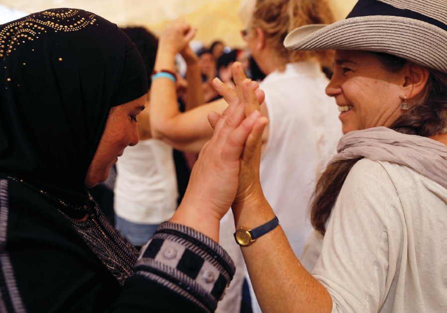 Women celebrate inside a peace tent erected as part of an event organized by ‘Women Wage Peace,’ near the Jordan River on October 8, 2017 Photo By: RONEN ZVULUN/REUTERS Women celebrate inside a peace tent erected as part of an event organized by ‘Women Wage Peace,’ nea