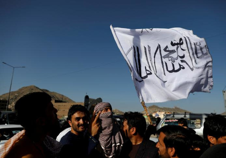 A member of the Taliban holds a flag in Kabul, Afghanistan June 16, 2018. The writing on the flag reads: 'There is no god but Allah, Muhammad is the messenger of Allah' Photo By: REUTERS/MOHAMMAD ISMAIL A member of the Taliban holds a flag in Kabul, Afghanistan