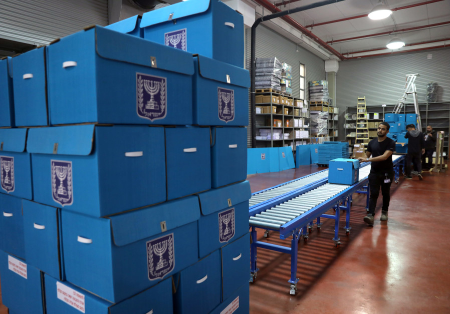 People sort ballot boxes as part of preparations for the upcoming Israeli election, during a briefing for members of the media at the Israel Central Election Committee Logistics Center in Shoham, Israel Photo By: REUTERS 95% of votes counted: 33 seats for Blue & White, 32 for Likud
